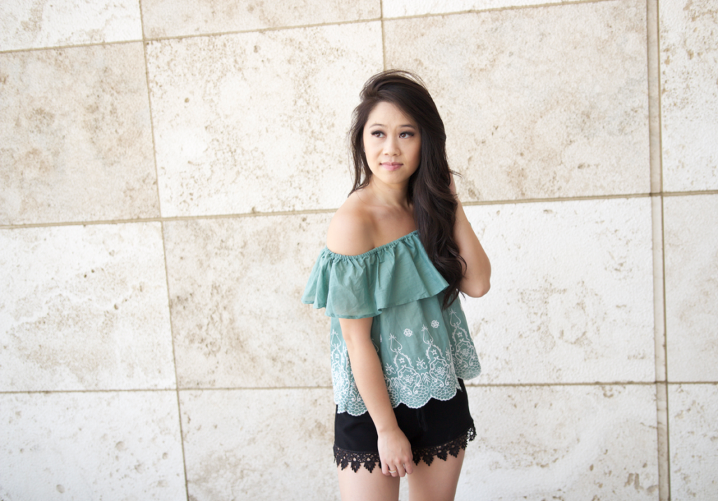 green off the shoulder top, black lace shorts